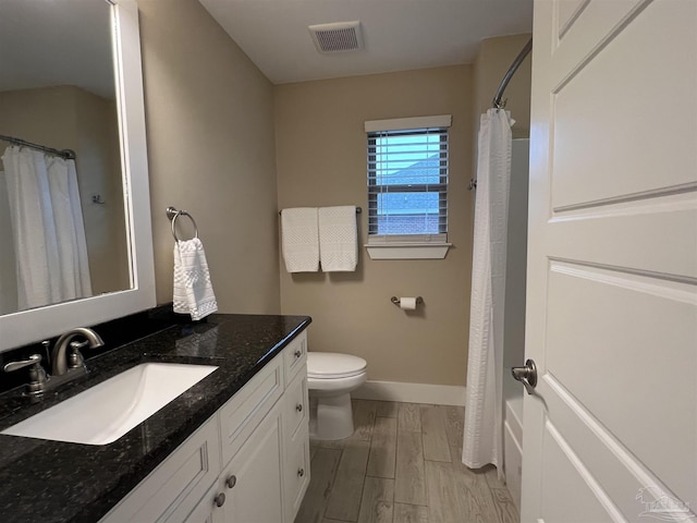 1792 Galvez Dr, Gulf Breeze, FL 32563 - bathroom featuring vanity, hardwood / wood-style floors, and toilet