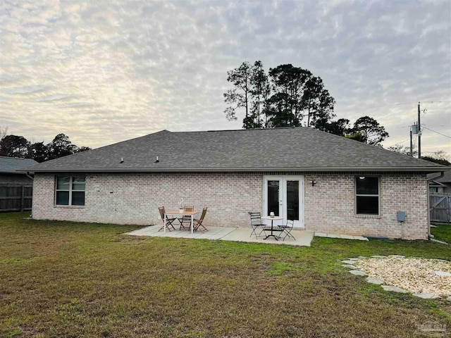 1792 Galvez Dr, Gulf Breeze, FL 32563 - rear view of house featuring a lawn, a patio, and french doors