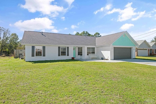 single story home featuring an attached garage, brick siding, concrete driveway, and a front yard