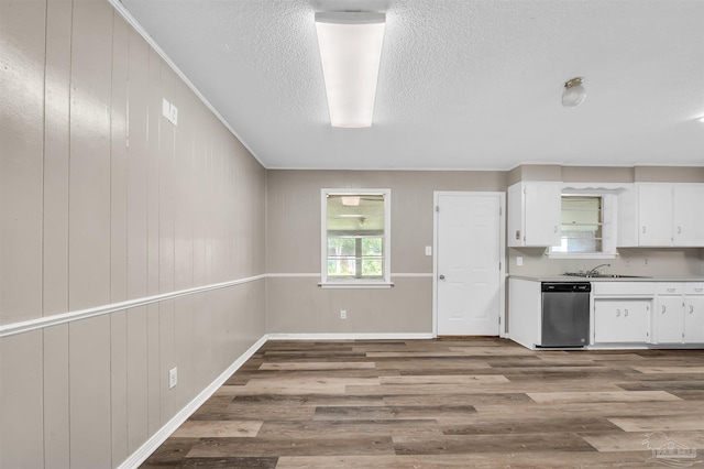 2382 Ryale Rd, Cantonment, FL 32533 - kitchen featuring dishwasher, white cabinets, wood finished floors, a sink, and light countertops