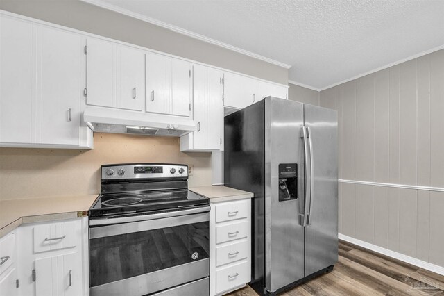 2382 Ryale Rd, Cantonment, FL 32533 - kitchen with stainless steel appliances, under cabinet range hood, light countertops, wood finished floors, and ornamental molding