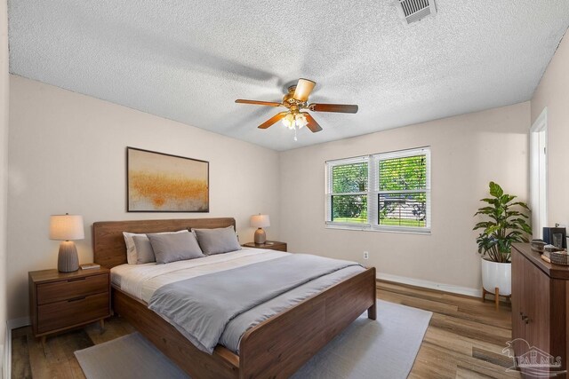 2382 Ryale Rd, Cantonment, FL 32533 - bedroom featuring wood finished floors, baseboards, a textured ceiling, and a ceiling fan