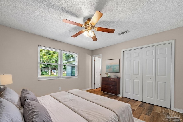2382 Ryale Rd, Cantonment, FL 32533 - bedroom with wood finished floors, a closet, a ceiling fan, a textured ceiling, and baseboards