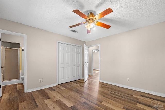 2382 Ryale Rd, Cantonment, FL 32533 - unfurnished bedroom featuring wood finished floors, baseboards, a closet, a textured ceiling, and ceiling fan