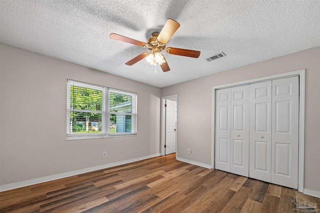 2382 Ryale Rd, Cantonment, FL 32533 - unfurnished bedroom with wood finished floors, baseboards, a closet, a textured ceiling, and a ceiling fan