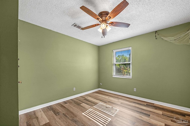 2382 Ryale Rd, Cantonment, FL 32533 - empty room with wood finished floors, a textured ceiling, ceiling fan, and baseboards