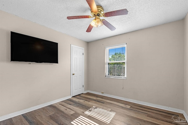 2382 Ryale Rd, Cantonment, FL 32533 - unfurnished bedroom with baseboards, a textured ceiling, wood finished floors, and a ceiling fan
