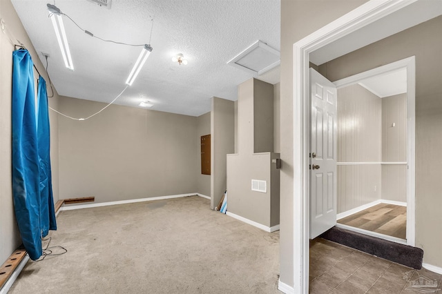 2382 Ryale Rd, Cantonment, FL 32533 - below grade area featuring a textured ceiling, baseboards, carpet, and baseboard heating