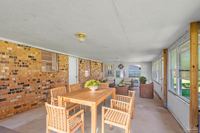 2382 Ryale Rd, Cantonment, FL 32533 - dining space with unfinished concrete floors and brick wall