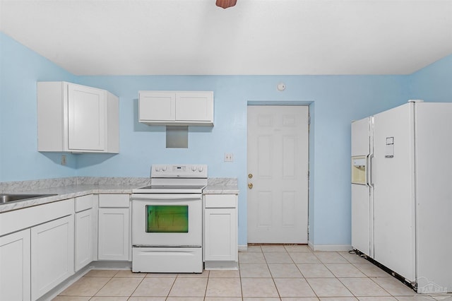 2382 Ryale Rd, Cantonment, FL 32533 - kitchen featuring white appliances, white cabinetry, light countertops, light tile patterned flooring, and baseboards