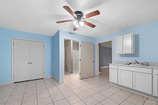 2382 Ryale Rd, Cantonment, FL 32533 - unfurnished bedroom with a sink, baseboards, a textured ceiling, ceiling fan, and a closet