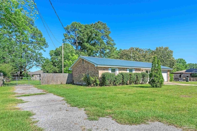 2382 Ryale Rd, Cantonment, FL 32533 - view of side of property with driveway, an attached garage, and brick siding