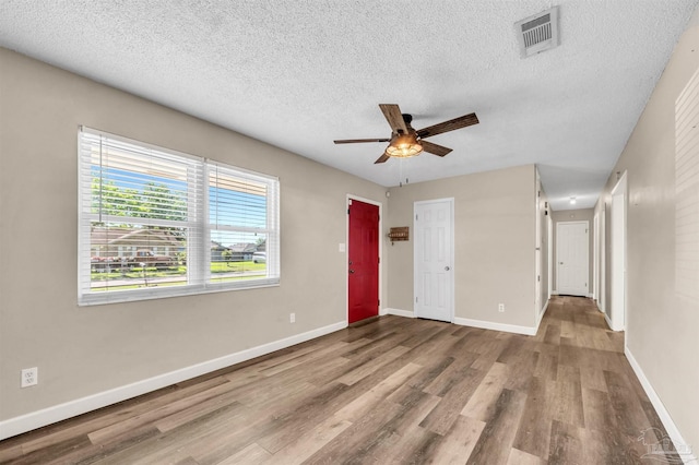 2382 Ryale Rd, Cantonment, FL 32533 - empty room featuring a ceiling fan, a textured ceiling, wood finished floors, and baseboards