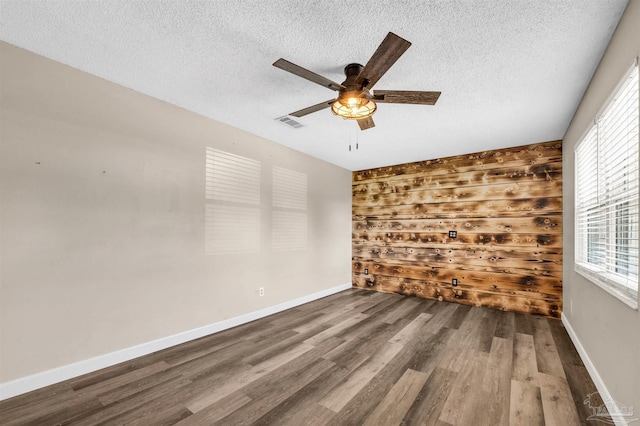 2382 Ryale Rd, Cantonment, FL 32533 - unfurnished room featuring a ceiling fan, wood finished floors, plenty of natural light, a textured ceiling, and baseboards