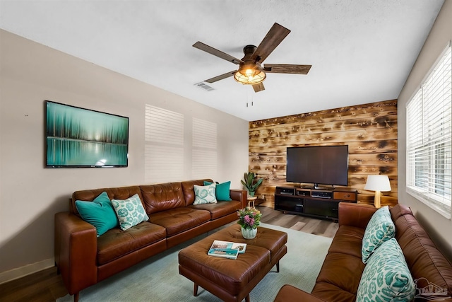 2382 Ryale Rd, Cantonment, FL 32533 - living area featuring wood finished floors, a ceiling fan, healthy amount of natural light, and wooden walls