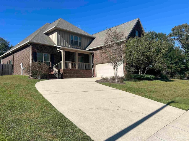 view of front of house with a porch, a garage, and a front yard