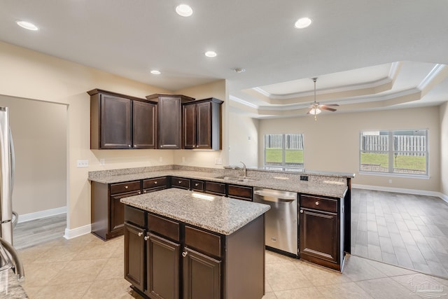 kitchen with ceiling fan, sink, stainless steel dishwasher, light hardwood / wood-style floors, and a kitchen island