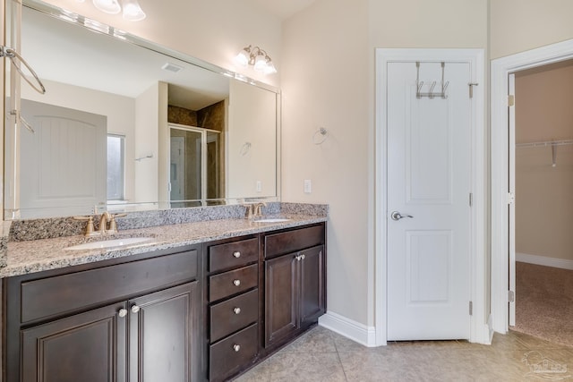 bathroom featuring tile patterned floors, vanity, and walk in shower