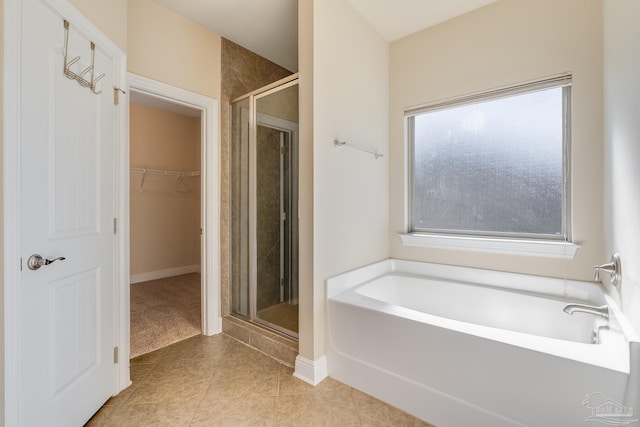 bathroom with tile patterned floors, plus walk in shower, and a wealth of natural light