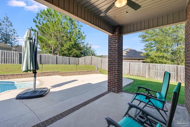 view of patio / terrace featuring ceiling fan and a fenced in pool