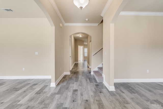 hall featuring light wood-type flooring and ornamental molding