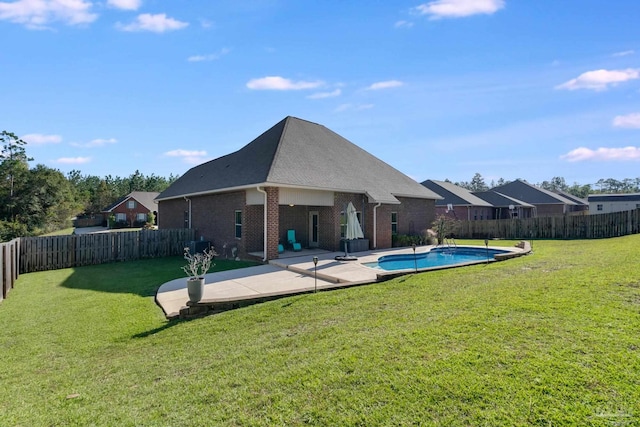 view of pool featuring a yard and a patio area