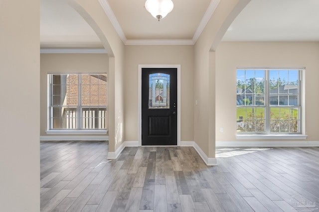 foyer with hardwood / wood-style floors and ornamental molding