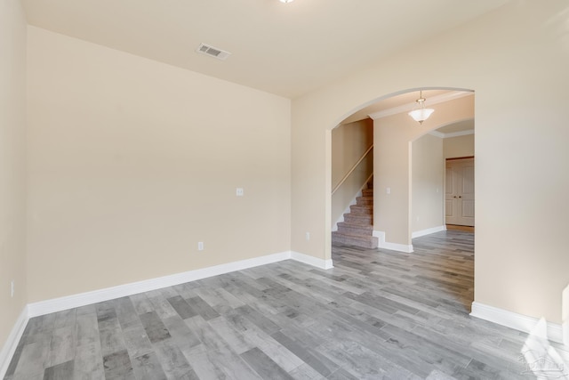 unfurnished room with ornamental molding and light hardwood / wood-style flooring