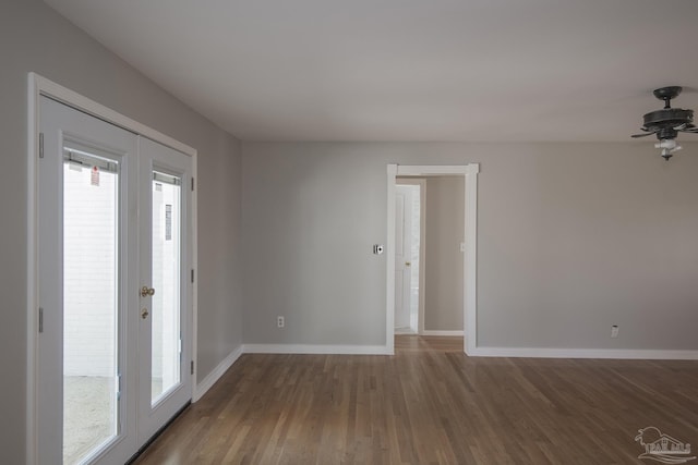 spare room with french doors, baseboards, and wood finished floors