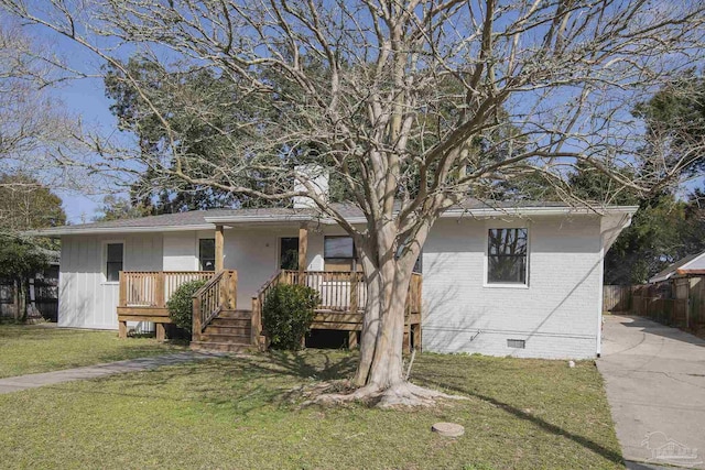 ranch-style home with a front lawn, brick siding, and crawl space