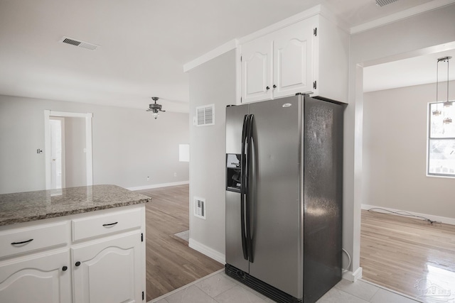 kitchen featuring visible vents, light wood-style floors, white cabinets, and stainless steel refrigerator with ice dispenser