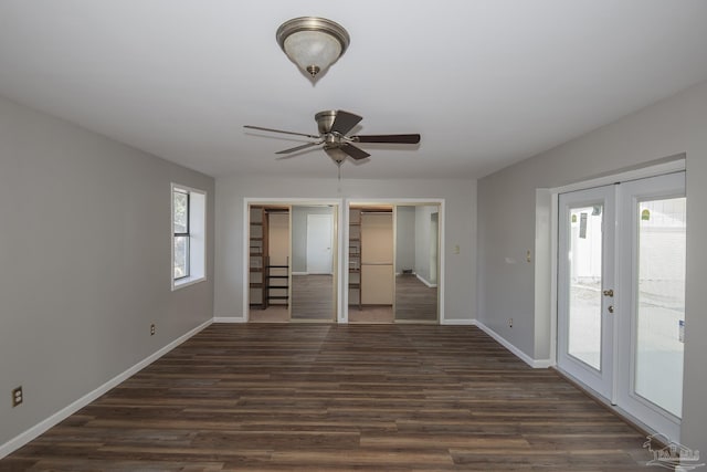 interior space featuring access to exterior, french doors, dark wood-type flooring, and baseboards