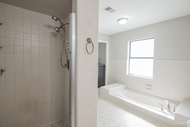 bathroom featuring a bath, visible vents, and a stall shower