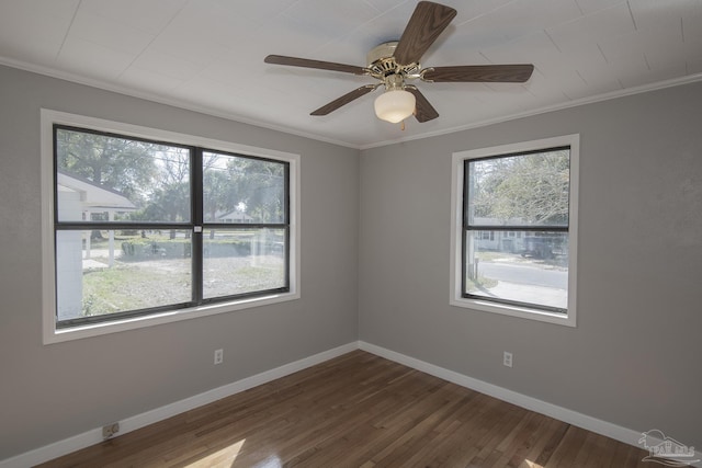 unfurnished room with baseboards, dark wood-style floors, a ceiling fan, and ornamental molding