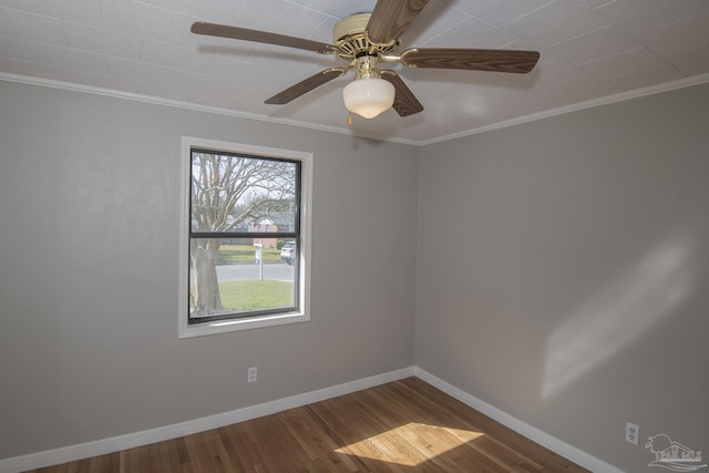 unfurnished room with ornamental molding, baseboards, and wood finished floors