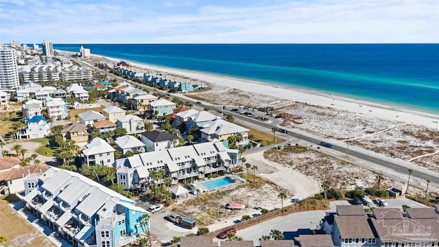 bird's eye view with a water view and a beach view