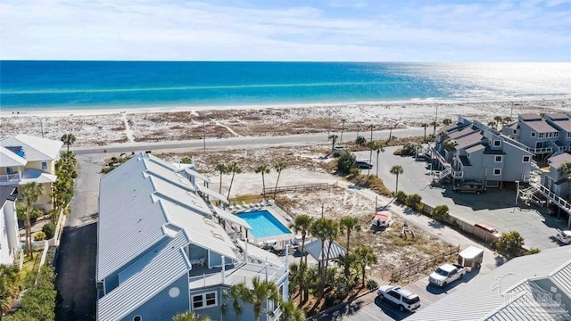 drone / aerial view featuring a water view and a beach view