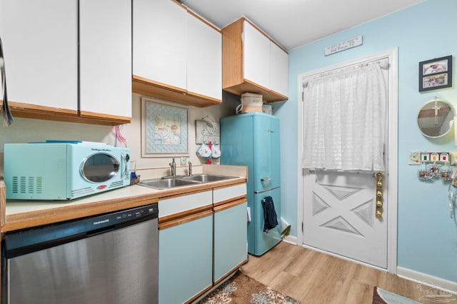 kitchen with dishwasher, sink, refrigerator, white cabinetry, and light hardwood / wood-style floors