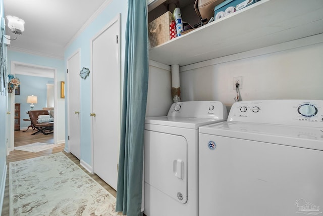 clothes washing area featuring light hardwood / wood-style flooring, independent washer and dryer, and crown molding