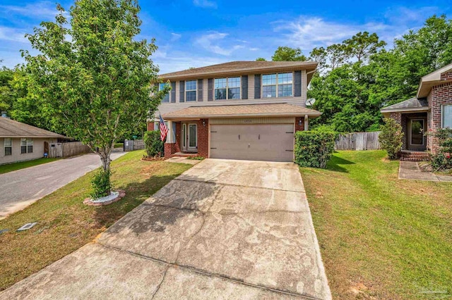 traditional-style home with a garage, a front lawn, fence, brick siding, and concrete driveway