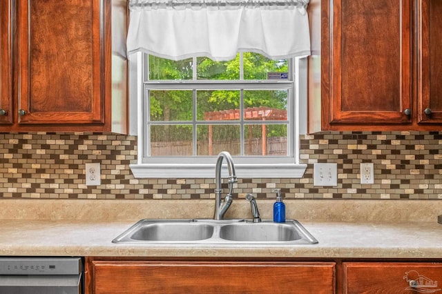 kitchen featuring a sink, backsplash, dishwasher, and light countertops