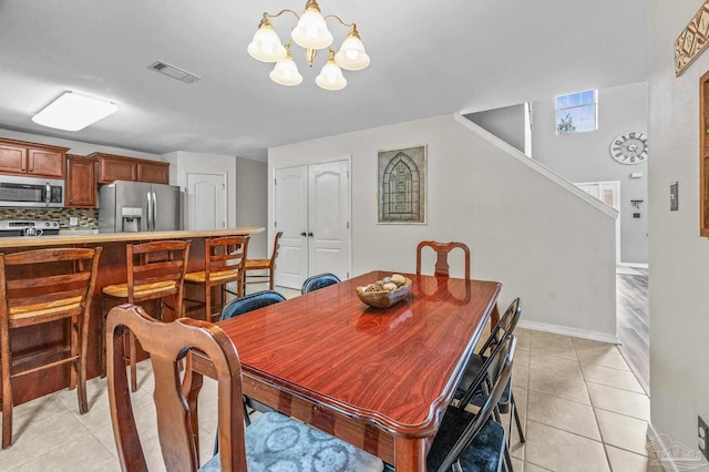 dining area with visible vents, stairway, baseboards, a notable chandelier, and light tile patterned flooring