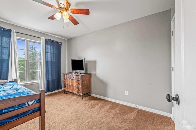 bedroom with carpet floors, a ceiling fan, and baseboards
