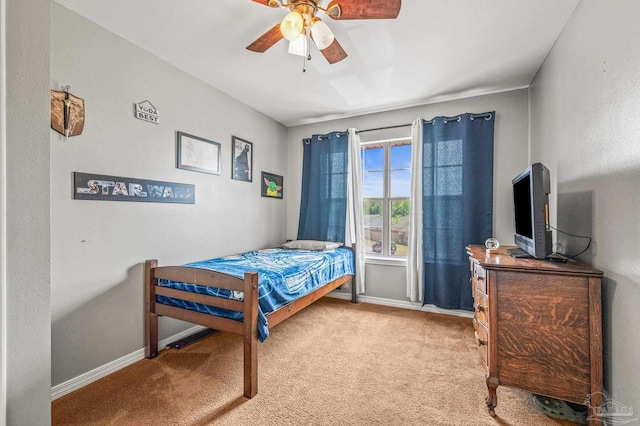 bedroom featuring baseboards, carpet flooring, and a ceiling fan
