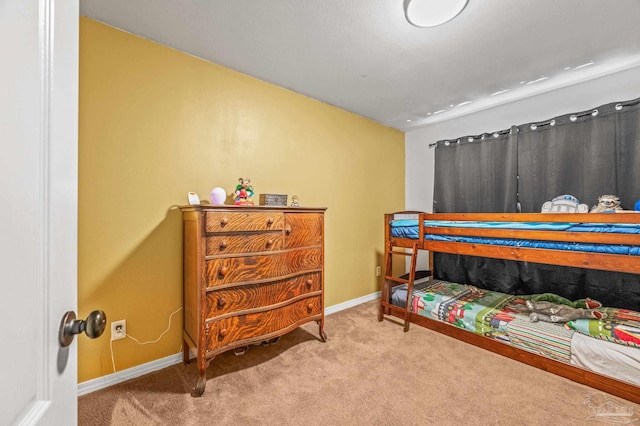 carpeted bedroom featuring baseboards