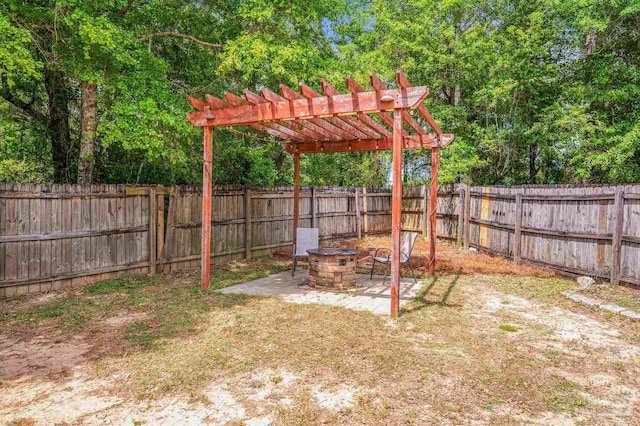 view of yard featuring a fenced backyard, a fire pit, a patio area, and a pergola
