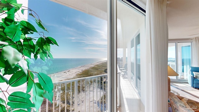 balcony with a water view and a beach view