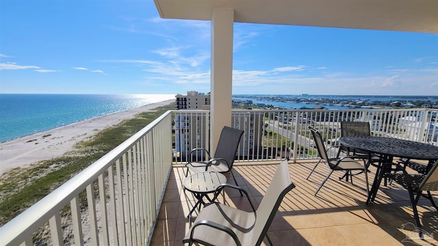 balcony featuring a water view and a beach view