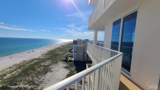 balcony featuring a water view and a view of the beach