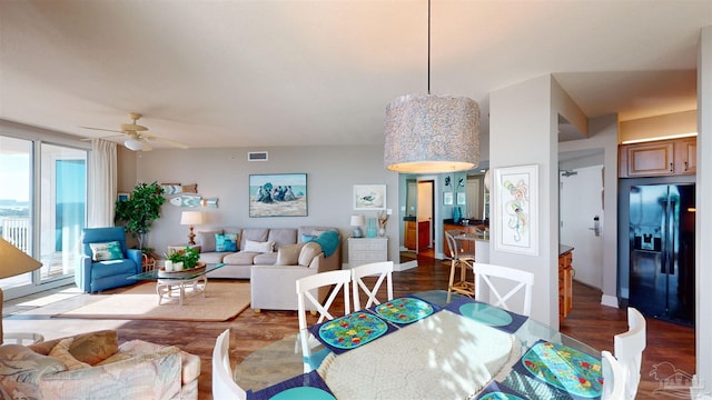 dining room with hardwood / wood-style flooring and ceiling fan